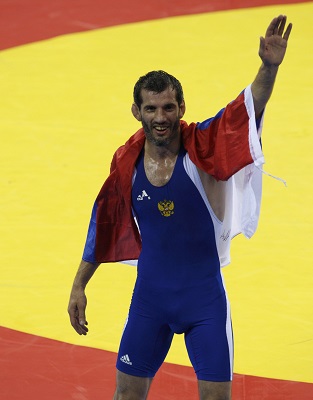 Buvaysa Saytiev of Russia celebrates after defeating Soslan Tigiev of Uzbekistan at the Beijing 2008 Olympic Games